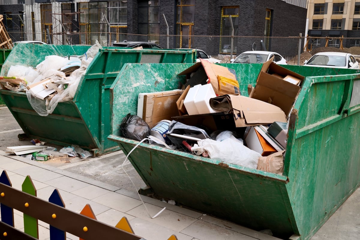 Overflowing construction dumpster filled with building waste